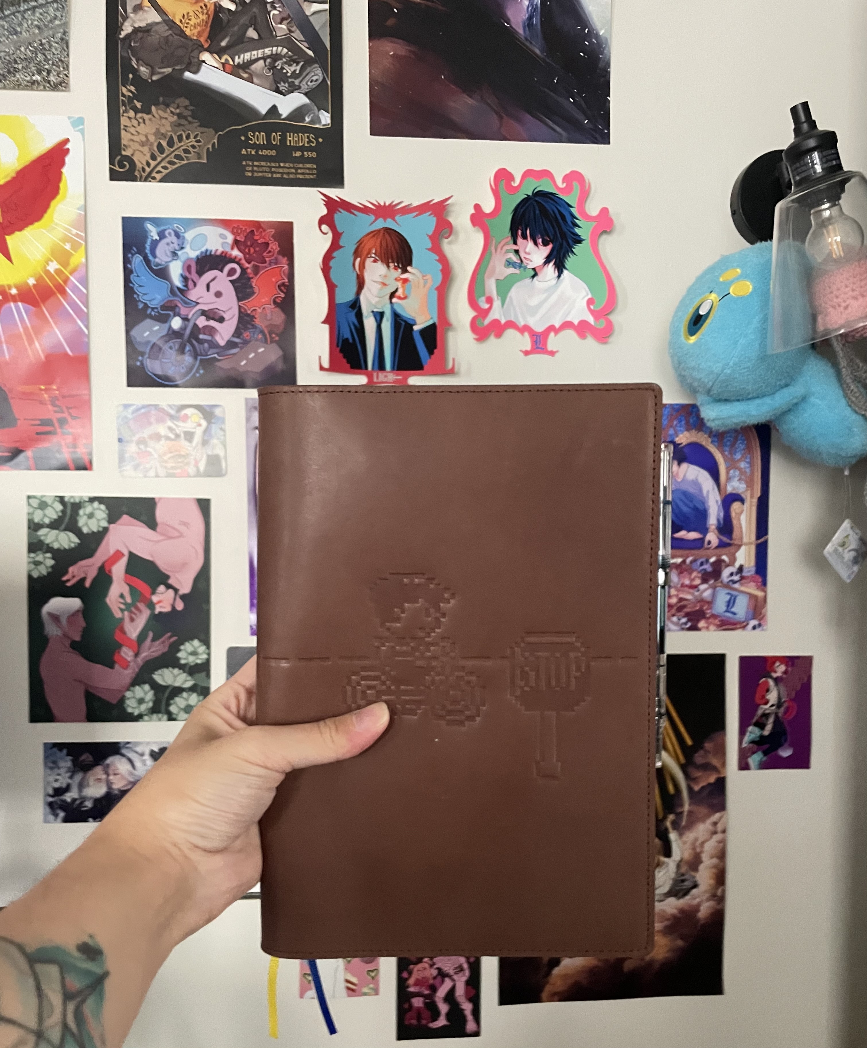 hobonichi cousin leather cover with an image of ness from earthbound on a bike embossed in it