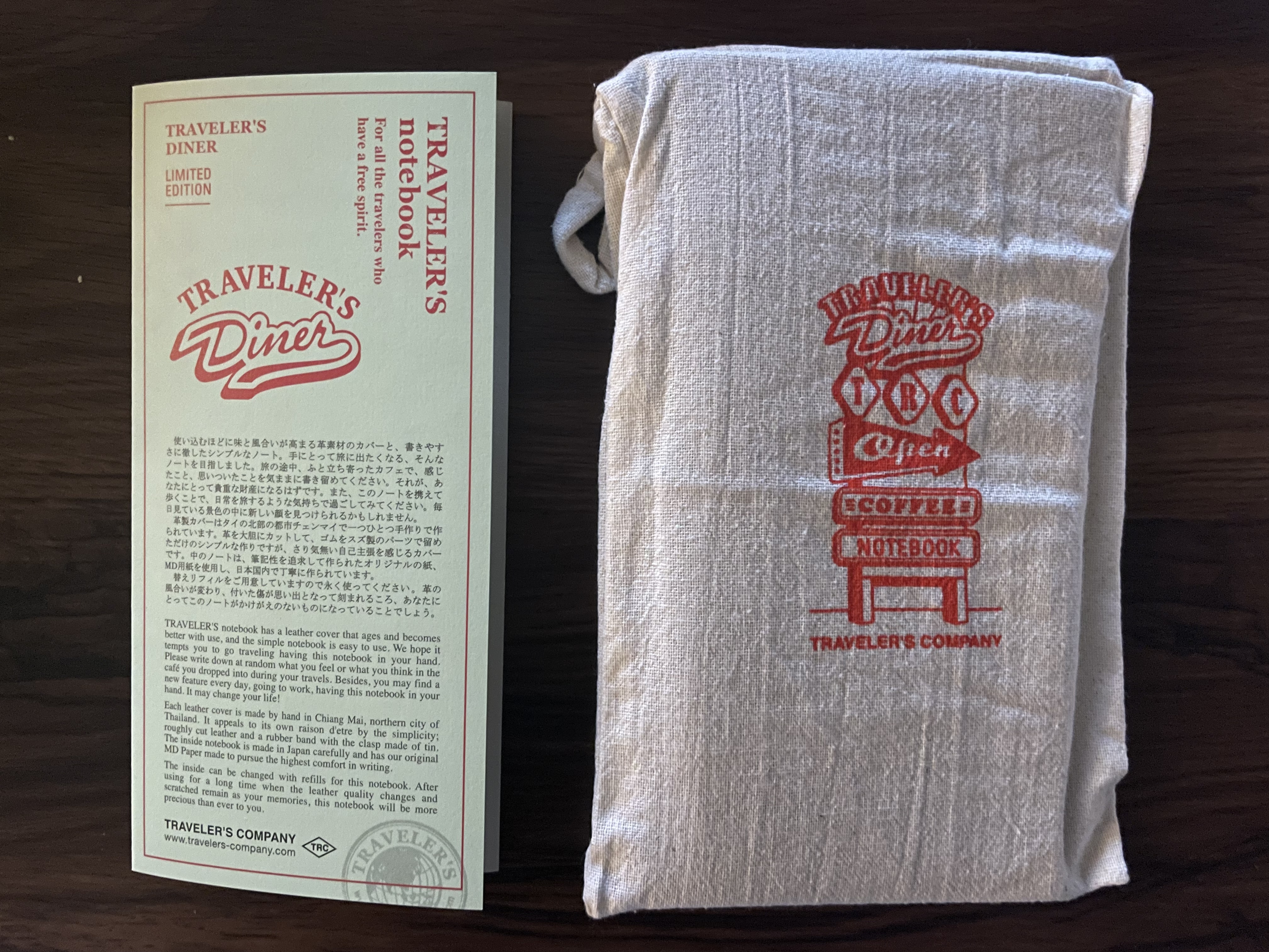 the pamphlet mentioned earlier side by side with the traveler's notebook kept in a cloth bag emblazoned with the traveler's diner design