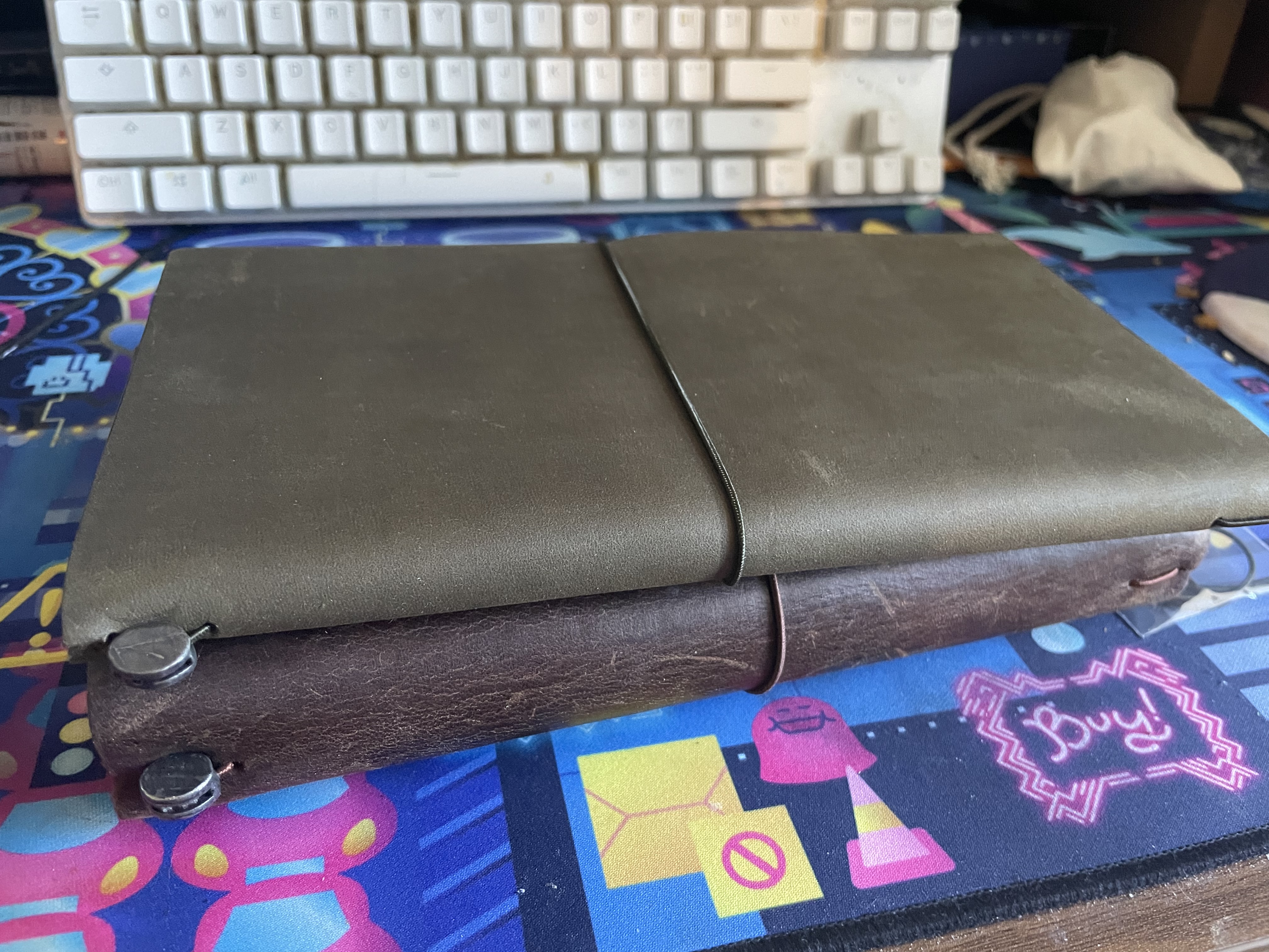 the olive traveler's notebook stacked on top of a brown traveler's notebook for comparison